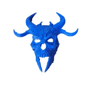 May include: A vibrant blue, horned skull mask with intricate details. The mask features large, curved horns, eye sockets, and a detailed skeletal structure. This decorative mask is suitable for costume parties or Halloween.
