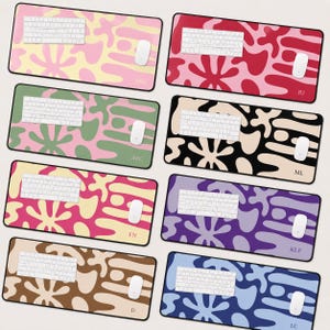 May include: Eight rectangular desk mats featuring abstract organic blob patterns in various color combinations. Each mat displays a white keyboard and mouse, with personalized initials printed in the bottom right corner of each surface.