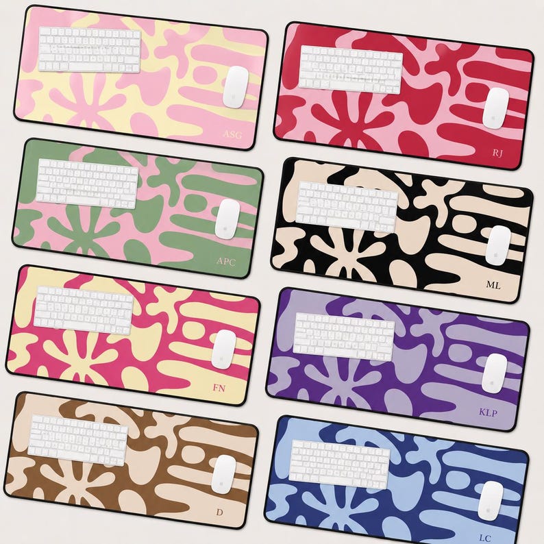 May include: Eight rectangular desk mats featuring abstract organic blob patterns in various color combinations. Each mat displays a white keyboard and mouse, with personalized initials printed in the bottom right corner of each surface.