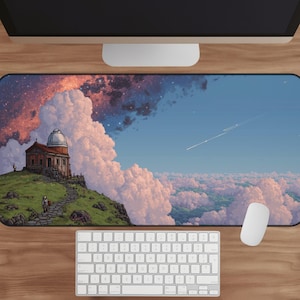 May include: A computer mousepad featuring a digital art landscape with a building on a hill, a person walking on a path, and a sky filled with clouds and stars. A white keyboard and mouse are in the foreground.