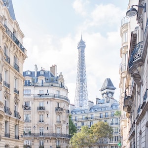 May include: A view of the Eiffel Tower from a narrow street in Paris, France. The tower is visible in the distance, with buildings lining the street on either side.