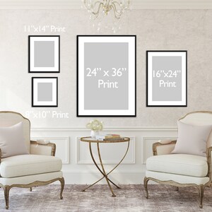 May include: A wall display featuring framed prints of various sizes: 20cm x 25cm, 28cm x 36cm, 41cm x 61cm, and 61cm x 91cm. The prints are displayed on a textured wall above two ornate armchairs and a small table. The text "Print" is visible on each frame.