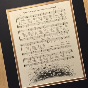 May include: A vintage sheet music print of the song "The Church In The Wildwood". The sheet music is printed on aged paper with a black and white illustration of wildflowers at the bottom of the page.