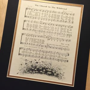May include: A vintage sheet music print of the song "The Church In The Wildwood". The sheet music is printed in black ink on white paper and features a black and white illustration of a woodland scene with flowers.