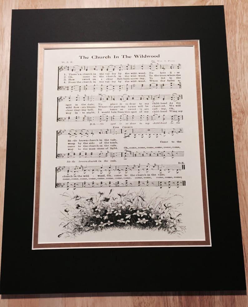 May include: A vintage sheet music page with the title "The Church In The Wildwood" and lyrics for the song. The sheet music features a black and white illustration of a small cluster of flowers in a field.