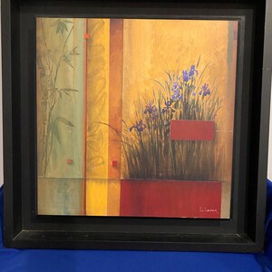 May include: Framed abstract painting with a yellow, orange, red, and green background. The painting features a cluster of purple flowers in the center.