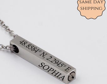 May include: Silver bar necklace with a personalized inscription that reads "48.8584° N, 2.2945° E SOPHIA".