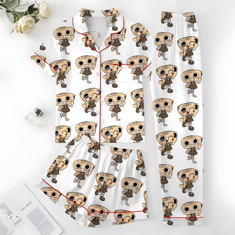 May include: A white pajama set with a repeating cartoon character pattern. The set comprises a short-sleeved button-up shirt, shorts, and long trousers. The shirt and shorts have red piping around the edges.