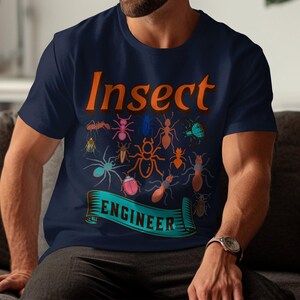 May include: A navy blue t-shirt with the text "Insect Engineer" in orange. The shirt features a variety of colorful insect illustrations.