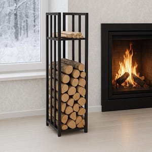 May include: A black metal log store filled with stacked logs. The rectangular rack has vertical bars and a shelf for kindling. A fireplace with a burning fire is in the background, and a window with a snowy view is visible.