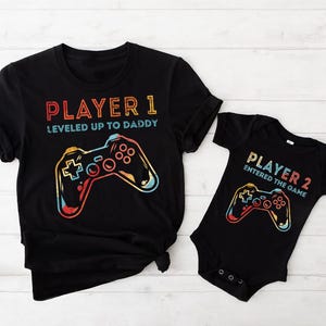 Koszulki rodzinne The Player, Koszulka z odblokowanym poziomem mamy, Koszulka z awansem na tatę, Koszulka z napisem „Gracz 2 wszedł do gry”, Koszulka z napisem „Baby Reveal”