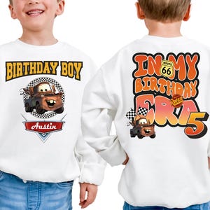two young boys wearing birthday sweatshirts with cartoon characters on them