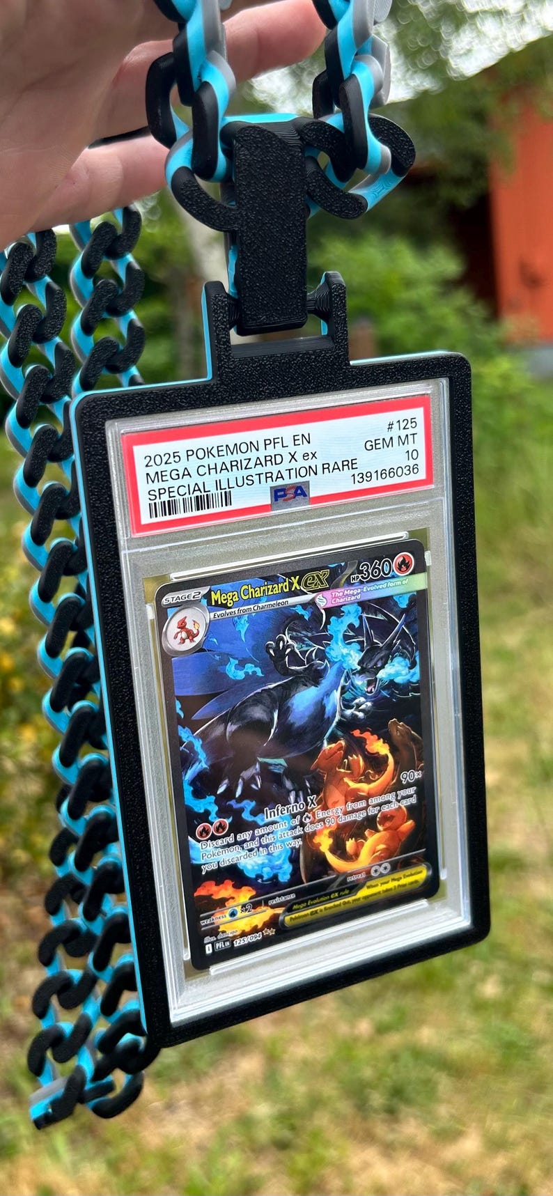 May include: A Pok&eacute;mon trading card featuring Mega Charizard X ex, graded GEM MT 10, with a special illustration. The card is encased in a protective holder with a black and blue lanyard.