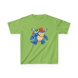 May include: A lime green t-shirt with a cartoon illustration of a blue, spiky, and muscular character with orange hair and a stern expression. The character has a green shell and two silver cannons on its back.