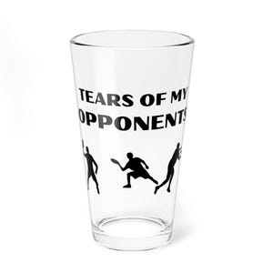 May include: Clear glass pint glass with the text "TEARS OF MY OPPONENTS" in black. Below the text are three black silhouettes of people playing a sport, likely pickleball or tennis.