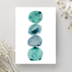 Modern abstract artwork of stacked pebbles in shades of blue and green. Original hand-drawn artwork using watercolour. Wall art for home