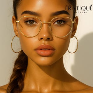 May include: A woman wearing gold-rimmed eyeglasses and large gold hoop earrings. The eyeglasses have a round frame. The image also features the text "ERATIQUE EYEWEAR".