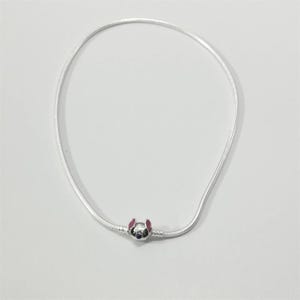 May include: A silver necklace featuring a charm of a cartoon character's face with pink ears and a blue face. The necklace is made of a thin, flexible silver chain.