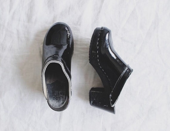 black patent clogs