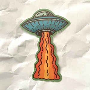 Retro UFO Sticker Cartoon Spaceship with Lava Beam Sci-Fi Pop Style for Laptop Journal Water Bottle.