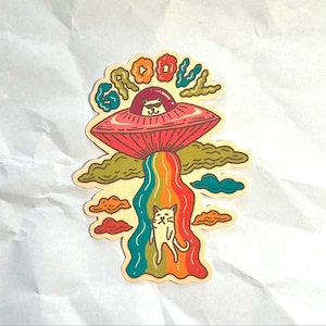 Sticker chat OVNI, sticker vinyle arc-en-ciel rétro, art amusant de chat extraterrestre, design de chat original, cadeau sur le thème de l'espace, sticker esthétique sympa.