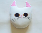 cat pillow with yellow eyes