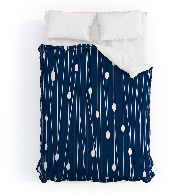 May include: A navy blue duvet cover with a white geometric pattern of lines and circles.