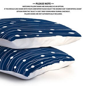 May include: Two navy blue pillowcases with a white abstract pattern of lines and circles. The pillowcases are stacked on top of each other.