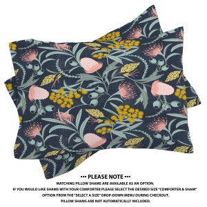 May include: Two navy blue pillow shams with a floral pattern featuring pink and yellow flowers. The text "...PLEASE NOTE..." is printed below the shams. "Matching pillow shams are available as an option. If you would like shams with your comforter please select the desired size "comforter & sham" option from the "select a size" drop-down menu during checkout. Pillow shams are not automatically included."