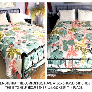 May include: A white comforter with a green, pink, and yellow cactus and succulent print. The comforter is on a black metal bed frame. The text "PLEASE NOTE THAT THE COMFORTERS HAVE A "BOX SHAPED" STITCH DETAIL. THIS IS TO HELP SECURE THE FILLING & KEEP IT IN PLACE." is at the bottom of the image.