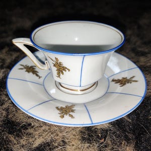 Vintage Porcelain Teacup and Saucer with Gold Floral Motif