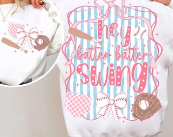 May include: White sweatshirt with a baseball theme. The design includes a pink and blue striped background with the words "Hey Batter Batter Swing" in pink. Baseball bat, ball, and glove graphics are also featured.