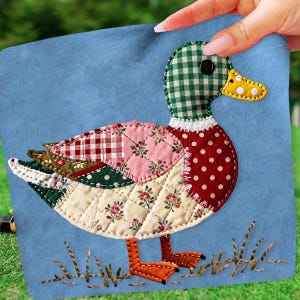 May include: A colorful, patchwork duck applique on a light blue square. The duck features a green and white checkered head, a red polka-dot body, and wings with floral and patterned fabrics. The duck has orange feet and a yellow beak.