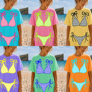 May include: Six t-shirts with bikini designs in various colours. The shirts are blue, pink, yellow, purple, green, and orange. The bikini designs have different colours and patterns, some with checkered patterns.