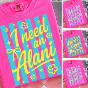 May include: Bright pink Comfort Colors t-shirts with various designs. One shirt features the text "I need an Alani" in yellow script with blue stripes and floral accents. Other shirts display phrases like "Mama needs a Margarita" and "Here Comes The Sun".
