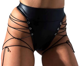May include: Black leather shorts with a high waist and lace-up details on the sides. The shorts have a fitted silhouette and are made of a smooth, shiny material.