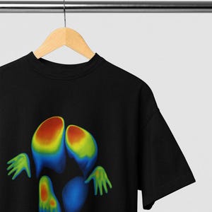 May include: Black t-shirt featuring a colorful, heat map-style graphic of a pair of feet and hands. The graphic transitions from red to blue, with green accents. The shirt is hanging on a wooden hanger.