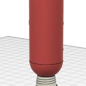 May include: A red and gray USB connector with a rounded top. The connector is designed to resemble a rocket ship.