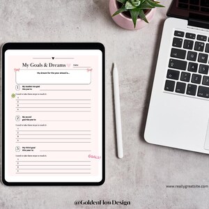 May include: A pink and white printable goal setting worksheet with the title "My Goals & Dreams". The worksheet has space to write down three goals and steps to achieve them.