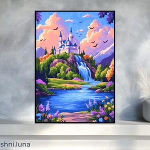 May include: A framed art print of a fantasy landscape. A white castle with blue accents sits atop a green hill with a waterfall. The scene includes a blue lake, colorful flowers, and birds flying in a pastel sky.