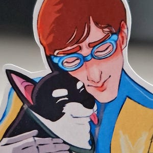 May include: A sticker featuring an illustration of a person with red hair and blue glasses hugging a black and white dog. The dog has its tongue out. The person is wearing a blue and yellow outfit.