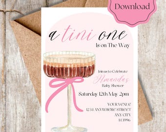 May include: Pink and white baby shower invitation featuring a martini glass illustration with the text "a tini one is on the way". The invitation includes the name "Amanda's Baby Shower", the date "Saturday 12th May 2pm", the venue "YOUR VENUE 1234 ANYWHERE STREET ANY CITY 143996", and the RSVP information "RSVP to Jane (515)254 213".