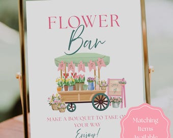 May include: A framed sign featuring a watercolour illustration of a flower cart, with the words "FLOWER Bar" at the top. The cart is filled with flowers and has a banner that says "BRIDE". The sign also says "Make a bouquet to take on your way. Enjoy!"