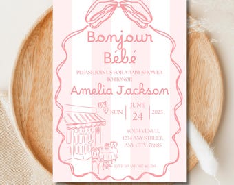 May include: Pink baby shower invitation with the words "Bonjour Bébé" and the name "Amelia Jackson." The invitation includes the date, venue, and RSVP information. The design features a bow and a cafe illustration.