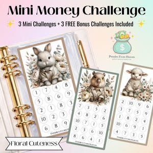 May include: A set of three mini money challenge cards featuring adorable animal illustrations: a bunny, a beaver, and a lamb. Each card has a numbered grid for tracking savings. The cards are part of a financial planning set, with the text "Mini Money Challenge".