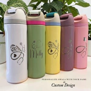 May include: Five colourful Owala water bottles with personalised designs. The bottles are white, green, yellow, purple, and pink. Each bottle features a stethoscope design and a name. The text at the bottom reads "Personalize Owala with your name & Custom Design."