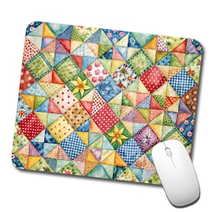 May include: A colorful patchwork mouse pad with a variety of geometric shapes and patterns in shades of red, blue, green, yellow, and white.