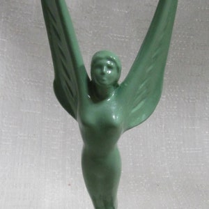 A Vintage Nina Saemundsson paperweight "Spirit of Achievement" art deco 10" tall in several finishes, on a marble base, Made in the USA.