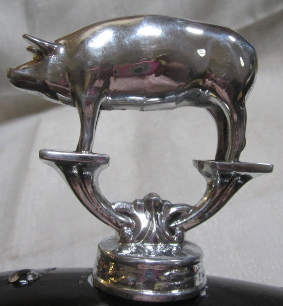 A Vintage Topper Harley Hog Pig motorcycle auto hood ornament mascot in Polished Aluminum