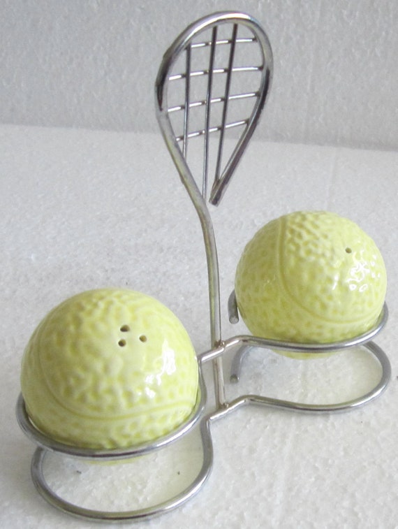 A Vintage Set of Ceramic Tennis Balls Salt and Pepper Shakers on a Metal Racquet Stand - 4-1/2 inches tall - Style #452